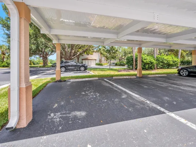 View of vehicle parking featuring a carport