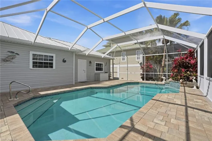 Outdoor pool with a lanai, a sunroom, and a patio