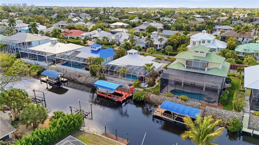 Aerial perspective of suburban area featuring a large body of water