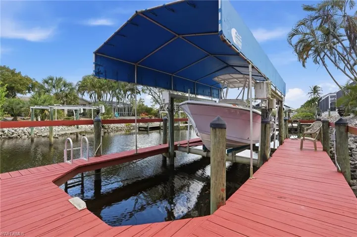 Dock featuring boat lift and a water view