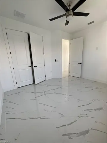Unfurnished bedroom featuring ceiling fan