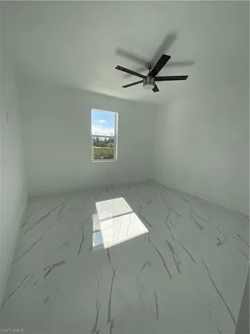 Empty room featuring ceiling fan
