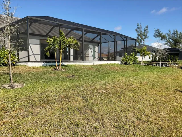 View of yard featuring glass enclosure