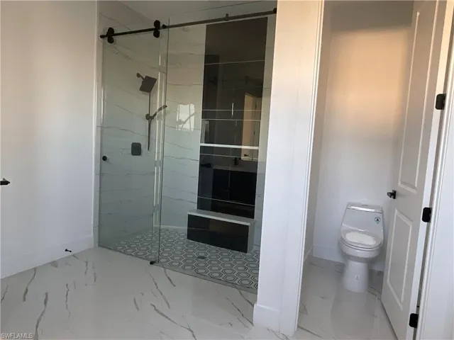 Bathroom with a tile shower and toilet