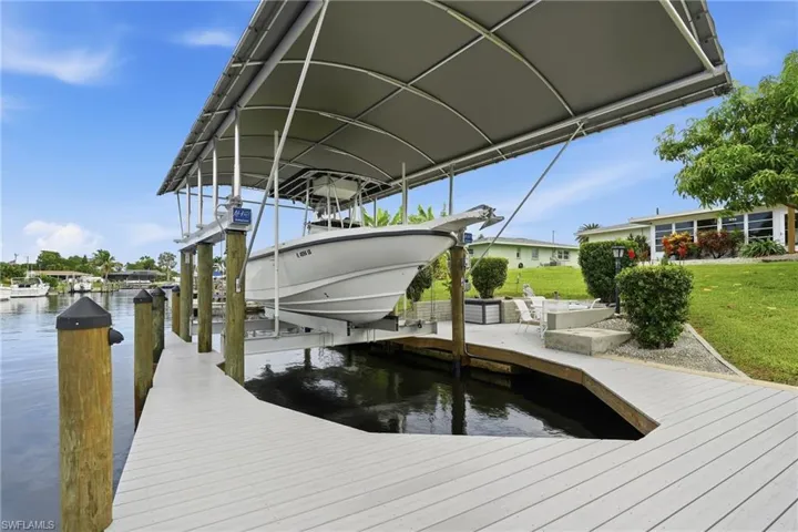 20k lb covered boat lift. Dock has water, electric, lighting and a submersible fish light.
