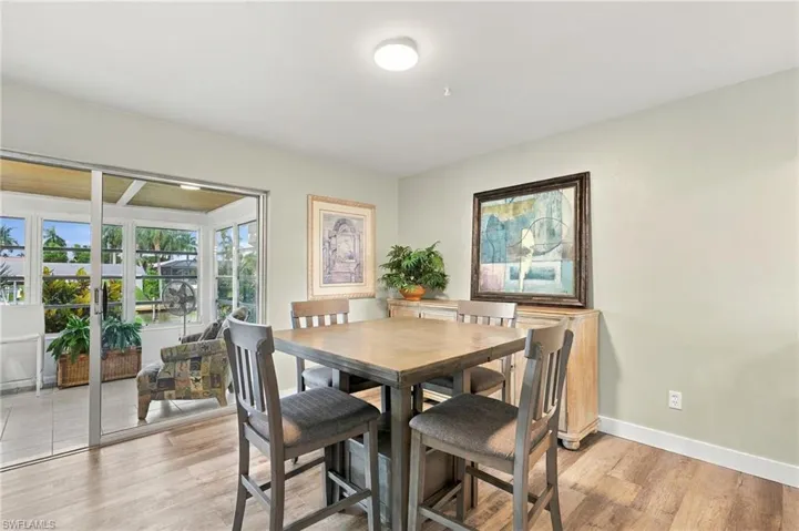 Sliding glass doors, wood-finish flooring, recessed lighting, and a neutral wall color