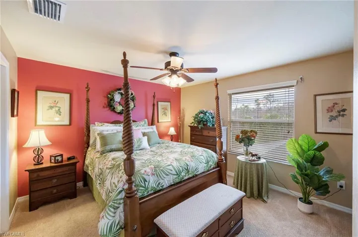 Bedroom featuring light carpet and a ceiling fan