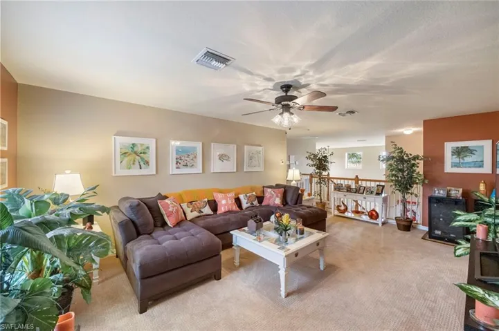 Living room with carpet and ceiling fan