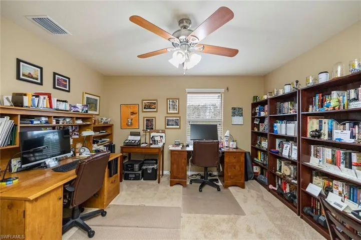 Office featuring light carpet and ceiling fan