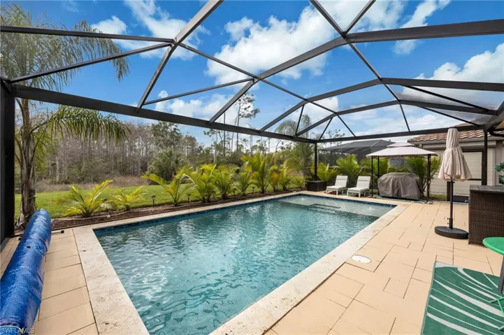 Outdoor pool featuring a lanai, a sunroom, area for grilling, and a patio area