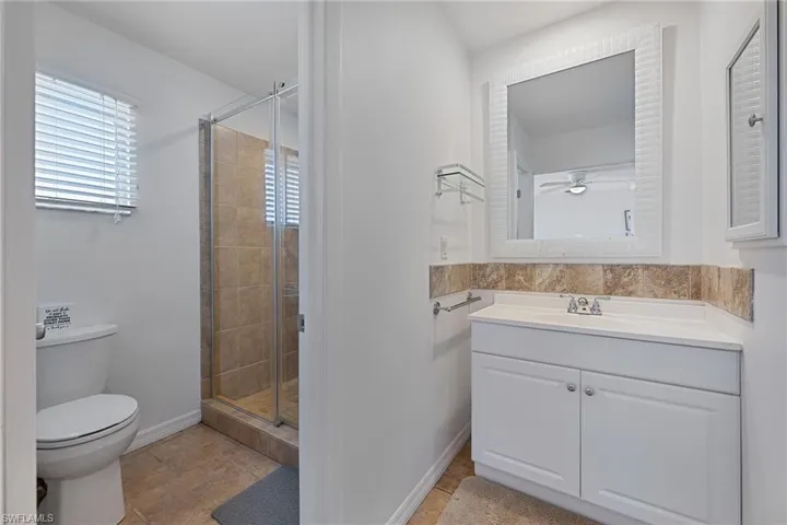Master bathroom featuring vanity and a shower stall