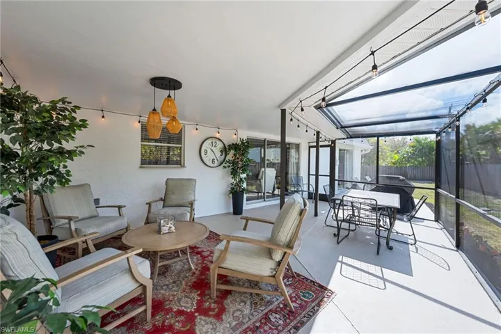 Screened in lanai with an outdoor living / dining area