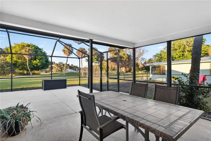 Spacious screened-in patio featuring a concrete floor, white ceiling, and expansive outdoor exposure