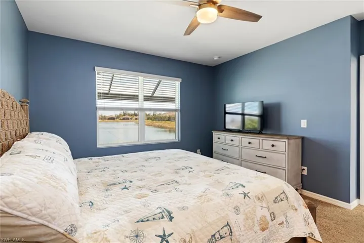 Primary bedroom has view of the pool and lake