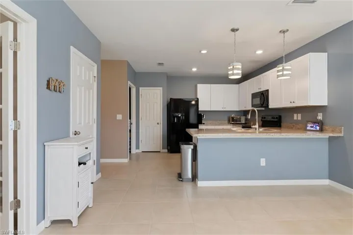 View from front door, kitchen ahead, den/office the left