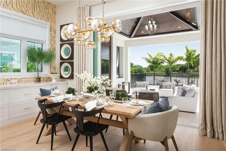 Dining room with wooden ceiling, a chandelier, and light wood-type flooring