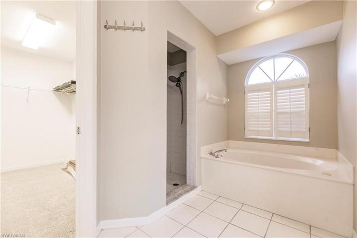 Primary En Suite with Walk in Closet and tiled shower space