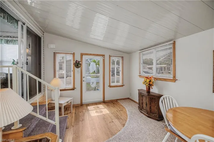 Foyer entrance with lofted ceiling and light wood-style floors