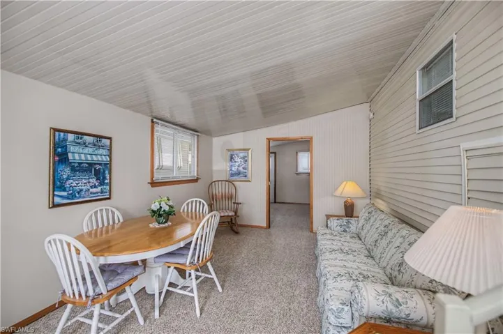Dining room featuring light carpet and lofted ceiling