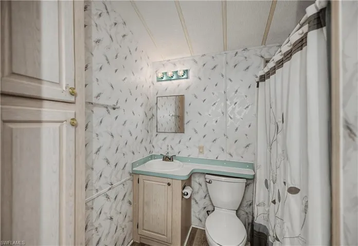 Full bathroom featuring vanity and a shower with curtain