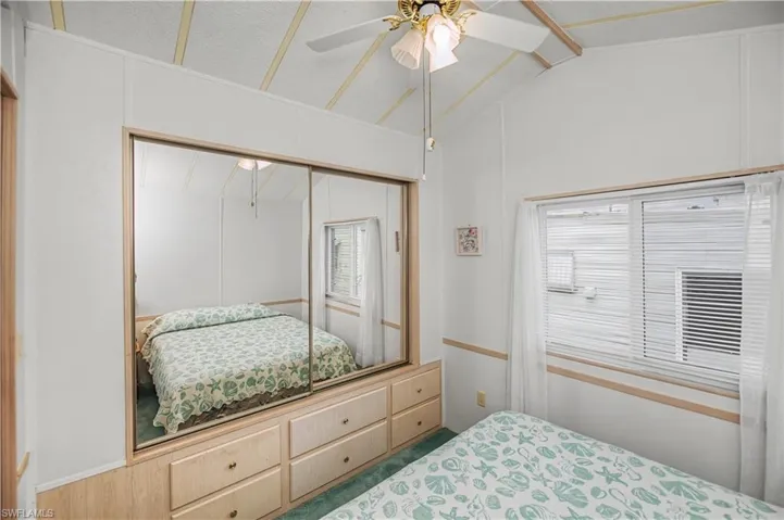 Bedroom with lofted ceiling, a closet, and ceiling fan