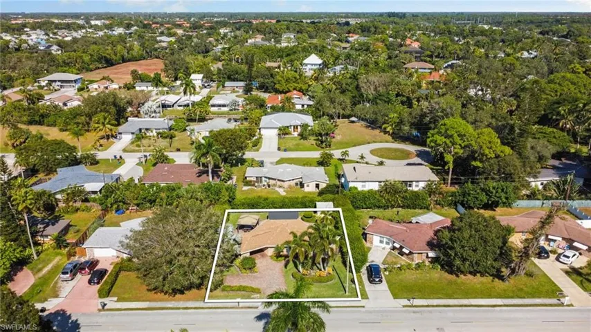 Aerial perspective of suburban area featuring property boundaries highlighted
