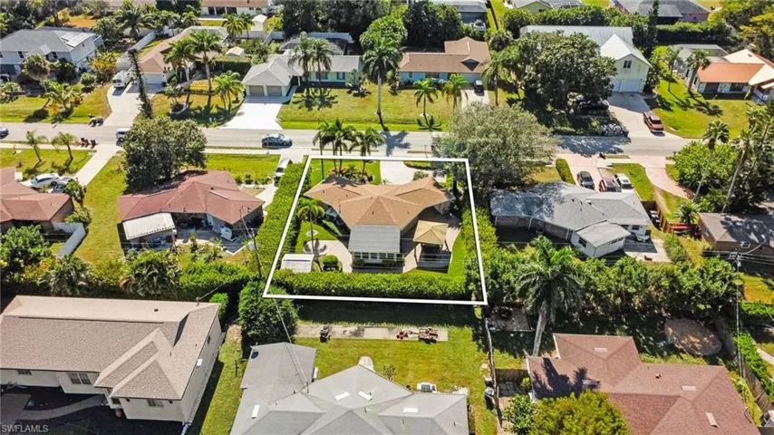Aerial perspective of suburban area featuring property parcel outlined