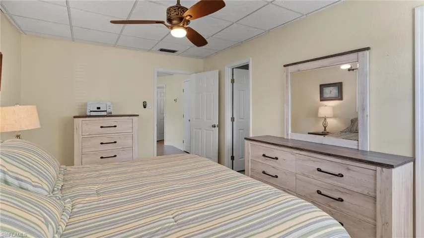 Bedroom featuring a drop ceiling and ceiling fan