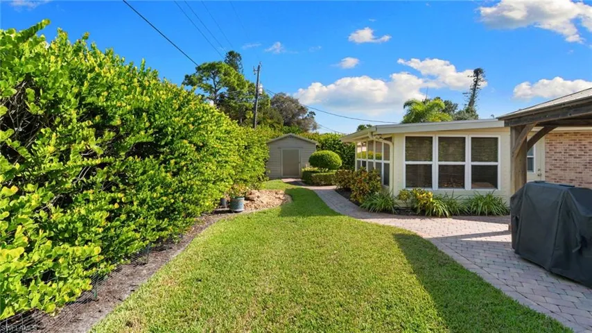 View of green lawn with a storage unit