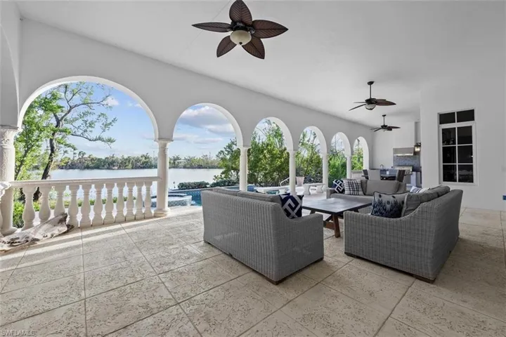 View of patio featuring an outdoor hangout area, a water view, and ceiling fan