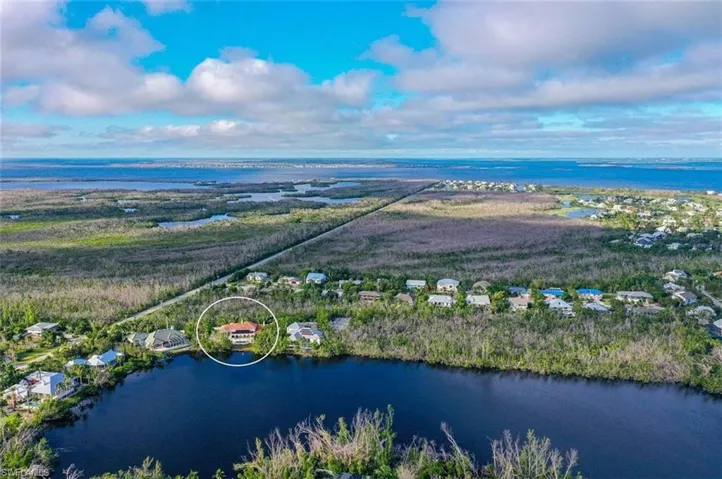 Birds eye view of property with a water view
