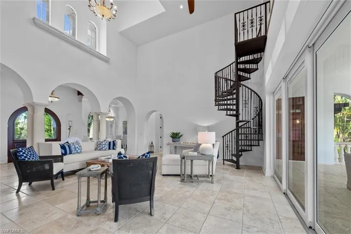 Living room with a notable chandelier and a towering ceiling