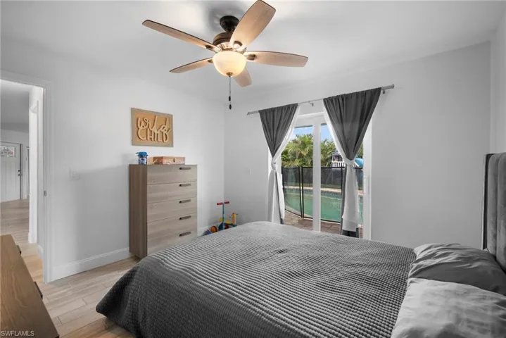 Bedroom featuring access to outside, light hardwood / wood-style floors, and ceiling fan