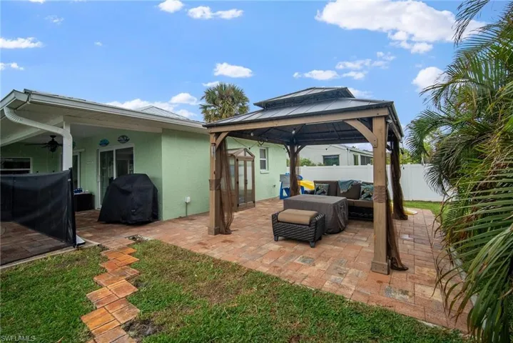 View of patio featuring ceiling fan, a gazebo, and grilling area