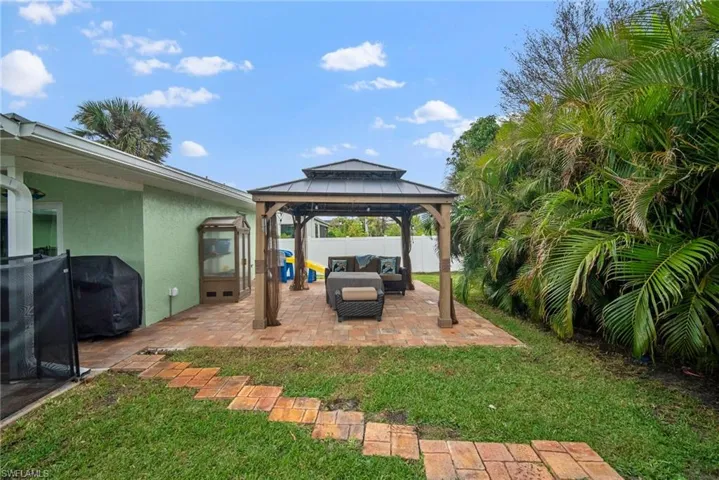View of yard featuring a patio, an outdoor hangout area, and a gazebo