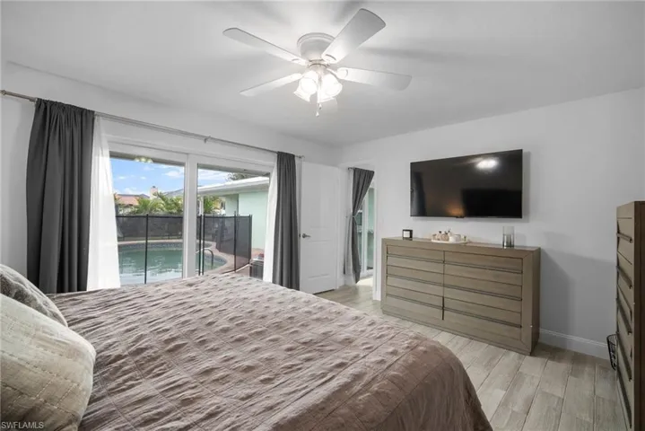 Bedroom featuring access to outside, ceiling fan, and light wood-type flooring