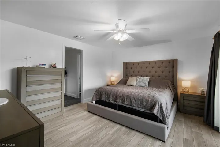 Bedroom with light hardwood / wood-style floors and ceiling fan