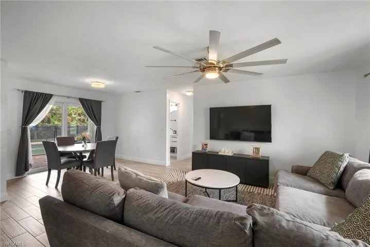 Living room featuring ceiling fan and light wood-type flooring