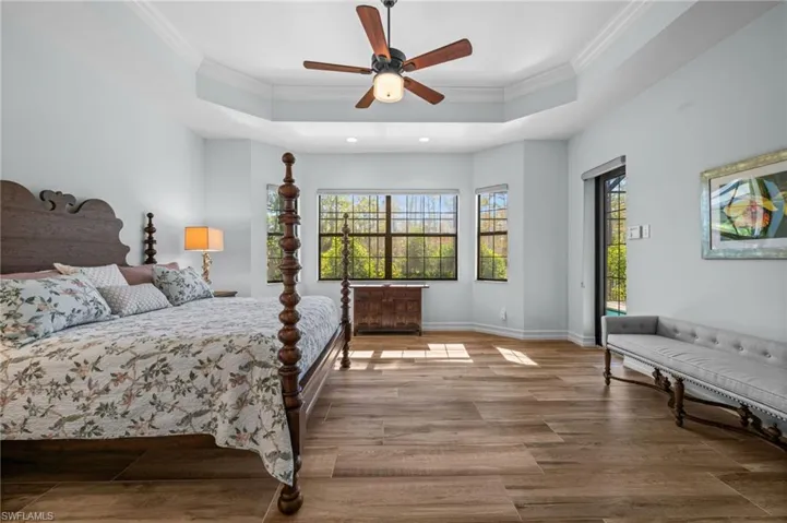 A serene primary suite filled with natural light and peaceful preserve views.