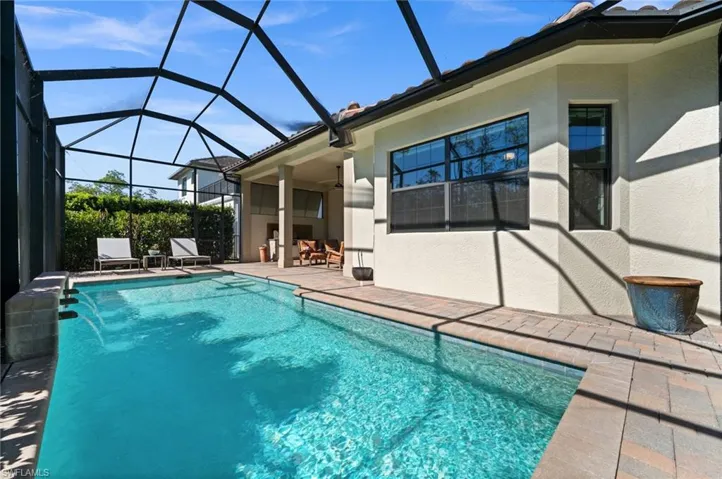 Refresh and unwind in this low-maintenance saltwater pool with cascading water features.
