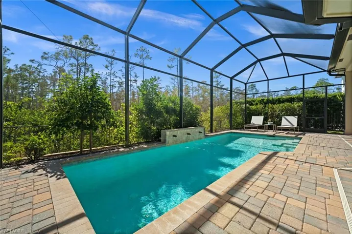 Your private retreat,  a solar-heated saltwater pool surrounded by serene preserve views.