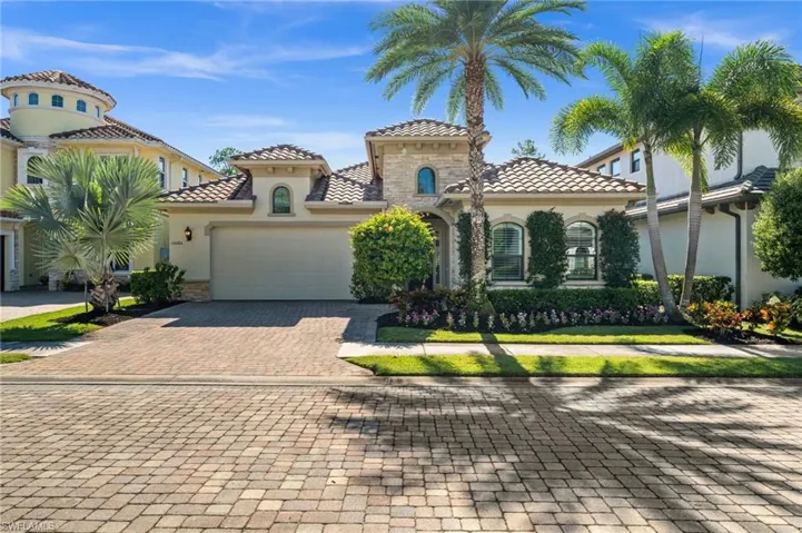 Stunning curb appeal and lush landscaping set the tone for this elegant Naples retreat.