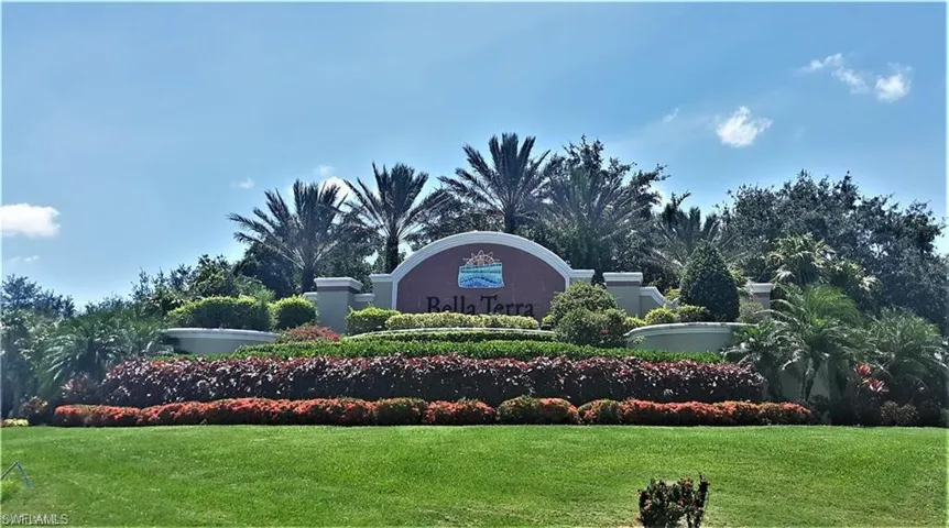 Community / neighborhood sign featuring a yard