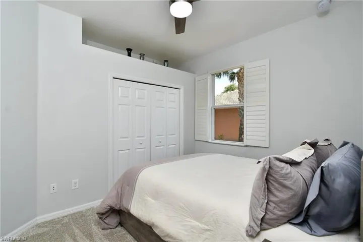 Bedroom featuring carpet flooring, a closet, and ceiling fan