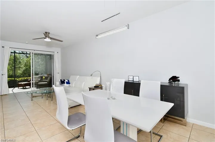 Tiled dining room featuring ceiling fan