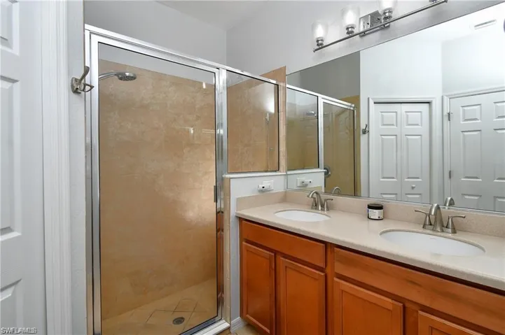 Bathroom featuring vanity and a shower with shower door