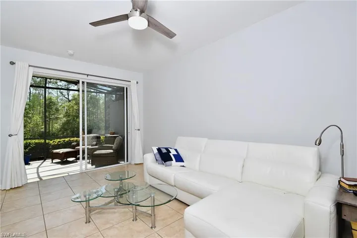 Living room featuring ceiling fan and light tile patterned flooring