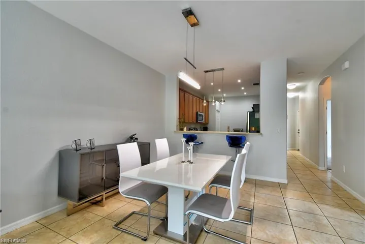 Dining area with light tile patterned floors