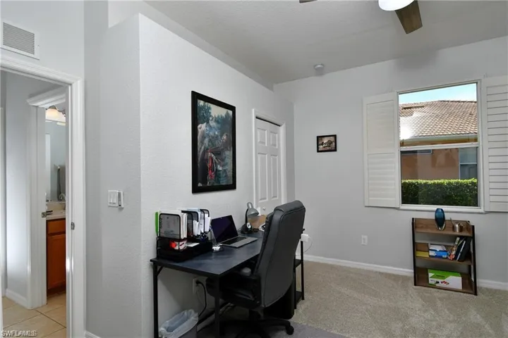 Office space featuring ceiling fan and light carpet