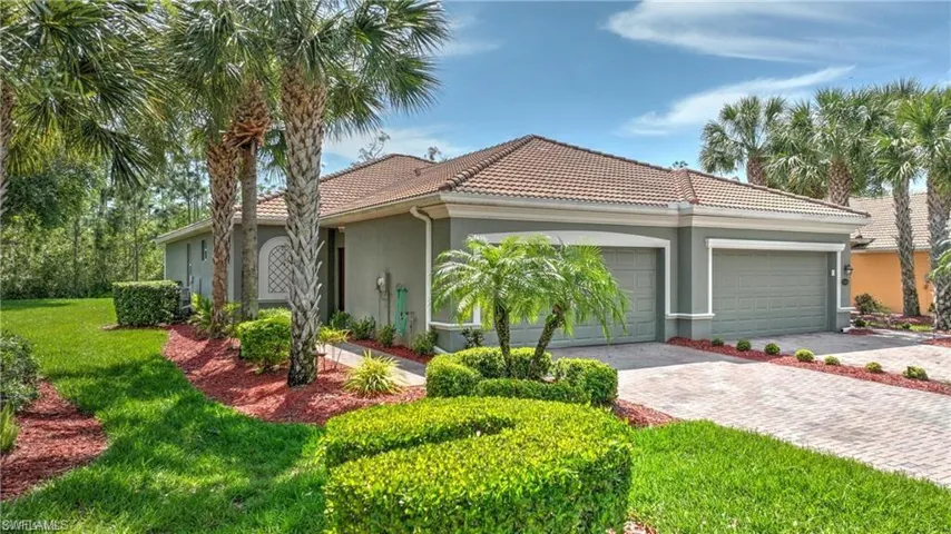 View of front facade featuring a garage and a front yard